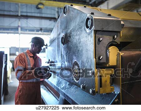 Engineer inspecting work in factory View Large Photo Image Stock Photography - Engineer inspecting work in factory. Fotosearch