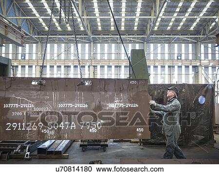 Engineer lifting steel plate in factory View Large Photo Image Stock Image - Engineer lifting steel plate in factory. Fotosearch