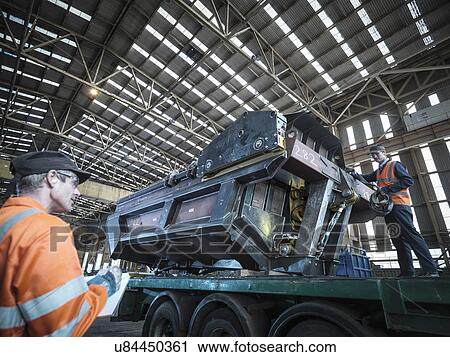 Engineer loading steel part onto truck in factory View Large Photo Image Stock Image - Engineer loading steel part onto truck in factory. Fotosearch