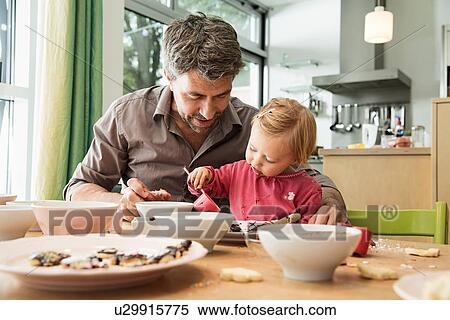 Father and daughter baking in kitchen View Large Photo Image Stock Photography - Father and daughter baking in kitchen. Fotosearch