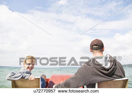 Stock Photo - Father and son on pedalo, Lake Ammersee, Bavaria, Germany. Fotosearch