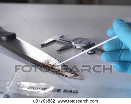 Stock Image - Forensic investigation of knife from crime scene. Fotosearch