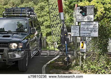 Four wheel vehicle driving over unmanned rail crossing, Kent, UK View Large Photo Image Stock Photograph - Four wheel vehicle driving over unmanned rail crossing, Kent, UK. Fotosearch