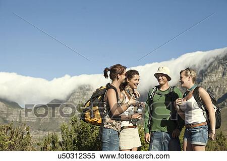 Stock Photography - Friends backpacking near Table Mountain, Cape Town, South Africa. Fotosearch