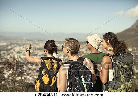 Friends looking at view from Table Mountain, Cape Town, South Africa View Large Photo Image Stock Image - Friends looking at view from Table Mountain, Cape Town, South Africa. Fotosearch