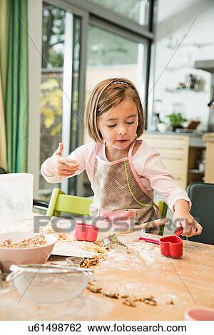 Stock Image - Girl baking in kitchen. Fotosearch