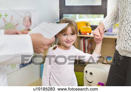 Girl holding hands with mother at dentists View Large Photo Image Stock Image - Girl holding hands with mother at dentists. Fotosearch