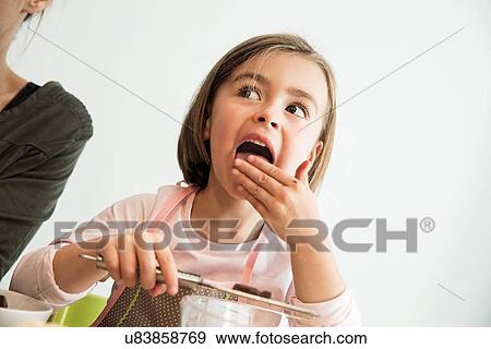 Girl licking batter from fingers View Large Photo Image Stock Photo - Girl licking batter from fingers. Fotosearch