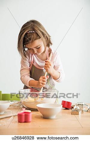 Stock Photo - Girl mixing batter in bowl. Fotosearch