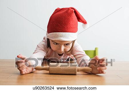 Girl staring at rolling pin View Large Photo Image Picture - Girl staring at rolling pin. Fotosearch