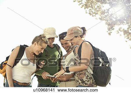 Group of young adult friends looking at map, Cape Town, South Africa View Large Photo Image Stock Image - Group of young adult friends looking at map, Cape Town, South Africa. Fotosearch