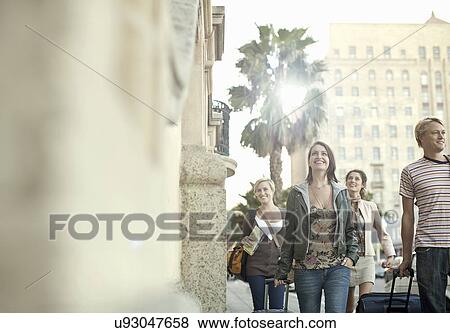 Group of young adult friends pulling suitcases, Cape Town, South Africa View Large Photo Image Stock Photo - Group of young adult friends pulling suitcases, Cape Town, South Africa. Fotosearch