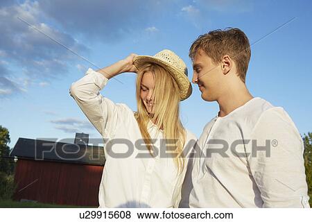 Happy young couple enjoying sunshine View Large Photo Image Stock Photo - Happy young couple enjoying sunshine. Fotosearch