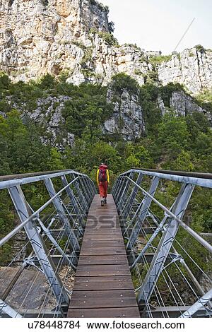 Picture - Hiker on hanging footbridge over the Verdon canyon, Provence, France. Fotosearch