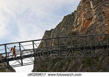 Hiker on hanging footbridge over Verdon Canyon, Provence, France View Large Photo Image Stock Photo - Hiker on hanging footbridge over Verdon Canyon, Provence, France. Fotosearch