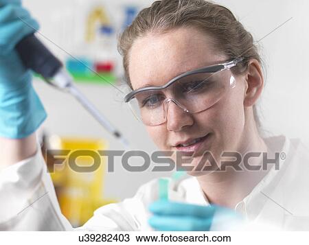 Laboratory worker pipetting sample into an eppendorf vial View Large Photo Image Stock Image - Laboratory worker pipetting sample into an eppendorf vial. Fotosearch