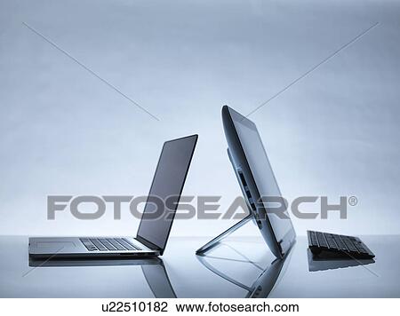 Stock Image - Laptop and PC on desk. Fotosearch