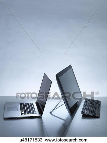 Laptop and PC on desk View Large Photo Image Stock Image - Laptop and PC on desk. Fotosearch