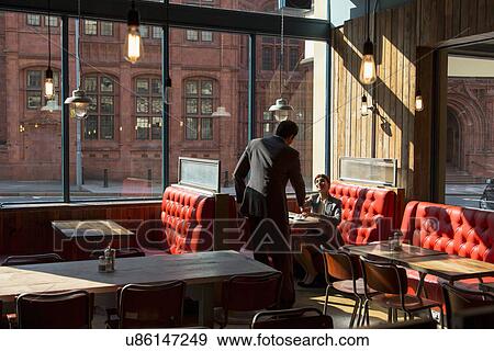 Man and woman shaking hands in restaurant View Large Photo Image Stock Photo - Man and woman shaking hands in restaurant. Fotosearch