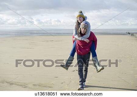 Man giving woman piggy back, Brean Sands, Somerset, England View Large Photo Image Stock Image - Man giving woman piggy back, Brean Sands, Somerset, England. Fotosearch