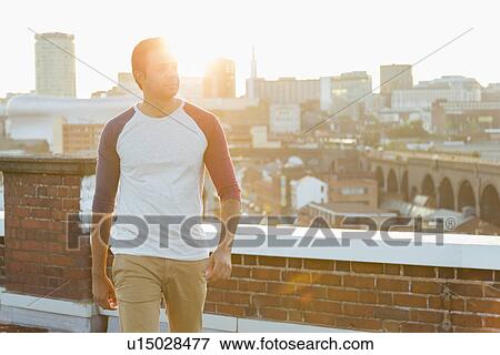 Man on rooftop, Birmingham, England, UK View Large Photo Image Stock Photo - Man on rooftop, Birmingham, England, UK. Fotosearch