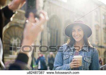 Man photographing young woman in hat View Large Photo Image Stock Photo - Man photographing young woman in hat. Fotosearch
