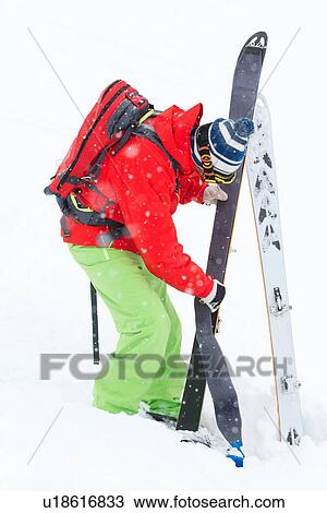 Stock Image - Man putting on skins for ski-touring, Kuhtai, Tirol, Austria. Fotosearch