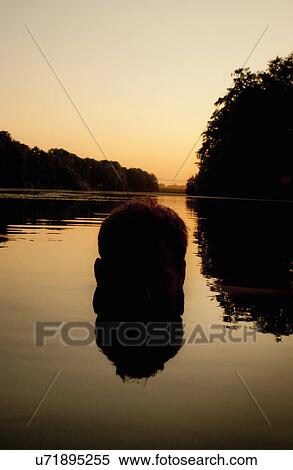 Stock Photography - Man's head submerged in water, Berlin, Germany. Fotosearch