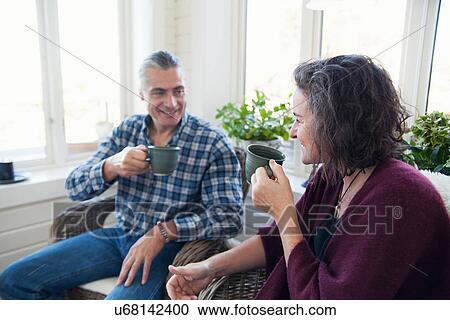 Mature couple having coffee break in conservatory View Large Photo Image Stock Image - Mature couple having coffee break in conservatory. Fotosearch