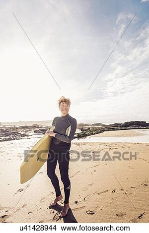 Mature female bodyboarder on Devon coast, UK View Large Photo Image Picture - Mature female bodyboarder on Devon coast, UK. Fotosearch