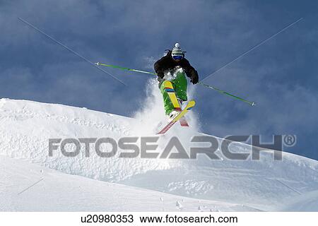 Stock Image - Mid adult man ski jumping in Kuhtai, Tirol, Austria. Fotosearch