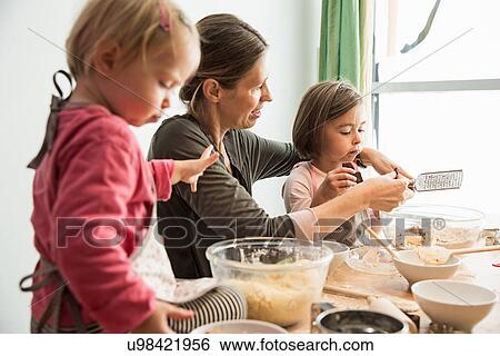 Mother and children baking View Large Photo Image Stock Photograph - Mother and children baking. Fotosearch