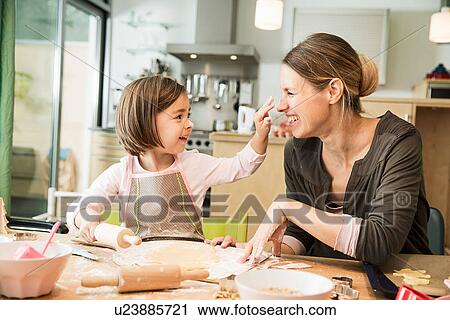 Mother and daughter baking in kitchen View Large Photo Image Stock Image - Mother and daughter baking in kitchen. Fotosearch