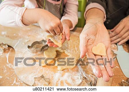 Mother and daughter baking in kitchen View Large Photo Image Stock Image - Mother and daughter baking in kitchen. Fotosearch