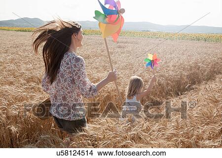 Mother and daughter running through wheat field View Large Photo Image Picture - Mother and daughter running through wheat field. Fotosearch
