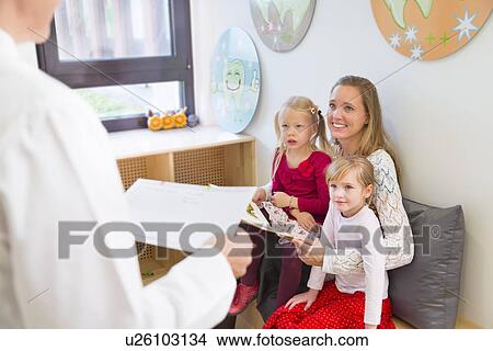 Mother with daughters in dentists waiting room View Large Photo Image Picture - Mother with daughters in dentists waiting room. Fotosearch