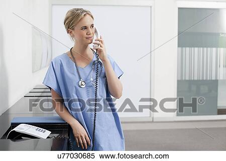 Stock Photography - Nurse making telephone call. Fotosearch
