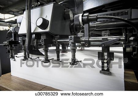 Stock Photo - Paper prepared in printing machine in print workshop. Fotosearch