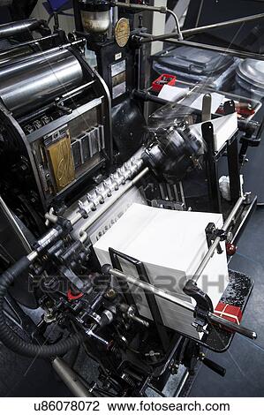 Stock Image - Paper printing machine at work in print workshop. Fotosearch