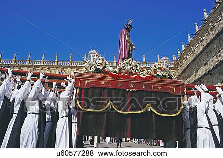 Stock Photo - Penitents lifting up Jesus Christ statue during Holy week celebration, Salamanca, Castilla Leon, Spain. Fotosearch