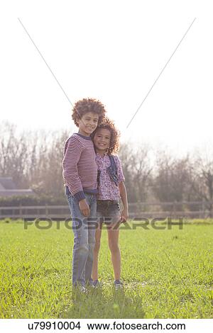 Portrait of brother and sister in sunlit field View Large Photo Image Picture - Portrait of brother and sister in sunlit field. Fotosearch