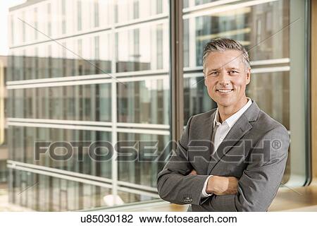 Portrait of businessman with arms crossed View Large Photo Image Stock Image - Portrait of businessman with arms crossed. Fotosearch