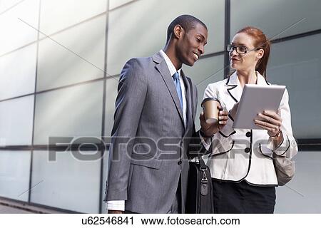 Stock Image - Portrait of businesspeople using digital tablet. Fotosearch