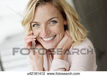 Portrait of businesswoman using mobile phone in office View Large Photo Image Stock Image - Portrait of businesswoman using mobile phone in office. Fotosearch
