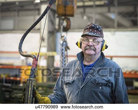 Portrait of crane operator in factory View Large Photo Image Stock Photo - Portrait of crane operator in factory. Fotosearch