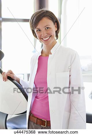 Stock Photo - Portrait of female dentist smiling. Fotosearch