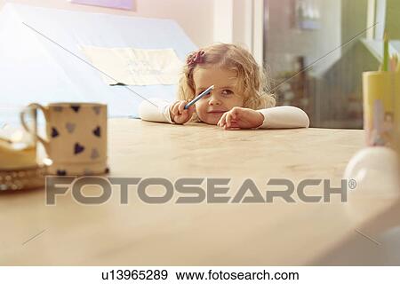 Portrait of female toddler leaning on kitchen table View Large Photo Image Stock Photo - Portrait of female toddler leaning on kitchen table. Fotosearch