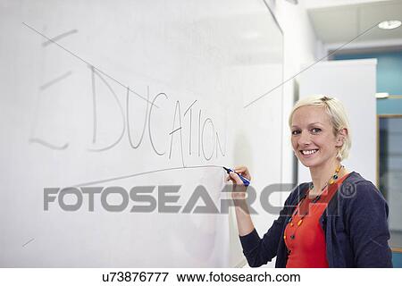 Portrait of female writing on white board View Large Photo Image Stock Photo - Portrait of female writing on white board. Fotosearch
