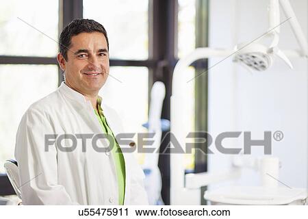 Stock Image - Portrait of male dentist smiling. Fotosearch