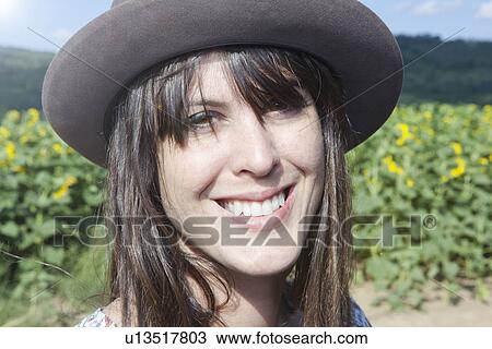 Portrait of mid adult woman wearing hat View Large Photo Image Stock Image - Portrait of mid adult woman wearing hat. Fotosearch